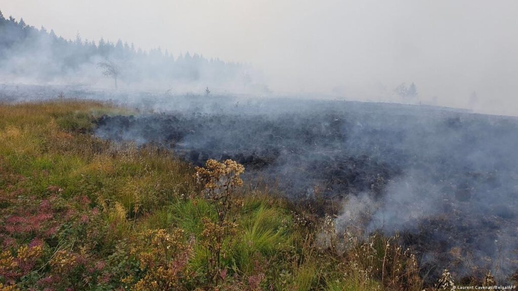Belgium is battling its largest wildfire on record after a huge blaze spread across the eastern High Fens nature reserve near the German border. The fire has burned about 2,700 hectares of land and forced hundreds of people to leave their homes. The Belgium wildfire evacuation began after changing winds and thick smoke raised fears that the fire could move toward nearby homes. Authorities ordered about 600 residents in parts of Waimes, Sourbrodt and Buetgenbach to leave the area. Tourists were also told to leave the region. The fire has created a major challenge for emergency crews. Much of the affected land is hard to reach. This has made it difficult for firefighters to work safely on the ground. “There is a risk that the fire could reach homes,” said Nicolas Yernaux, a spokesperson for regional authorities in Wallonia. He said teams were using all available resources to protect homes and local communities. Belgium has sent more firefighters to the area as crews work to slow the spread of the blaze. But the rough land has limited ground operations. In some areas, firefighters have had to let the fire burn because the locations are too difficult to reach. EU sends aircraft to help Belgium Belgium has also asked for help through the European Union civil protection system. The EU response includes three helicopters and two water bombing aircraft. The aircraft came from the Czech Republic, Sweden and the Netherlands. They are being used to drop water on parts of the fire that are hard for ground teams to reach. Firefighters from Germany and Luxembourg have also joined the effort. Local farmers are helping emergency teams by using their equipment and water to wet areas around the fire zone. The joint response shows the scale of the emergency. Belgium is using air support and crews from several countries to prevent the fire from spreading toward homes and other areas. The fire comes during a period of very high heat across Belgium. Temperatures reached 37 degrees Celsius in parts of the country this week. Hot weather can dry plants and soil, giving wildfires more fuel. Scientists say climate change is making hot and dry weather more likely in many parts of Europe. These conditions can help fires spread faster and burn for longer periods. European Commissioner Hadja Lahbib described the Belgian fire as another sign of major climate changes affecting Europe. She said wildfire seasons are starting earlier and reaching areas farther north than in the past. The High Fens fire is also close to a major wildfire in western Germany. That blaze forced more than 2,000 people to leave their homes before firefighters brought it under control. The fires in Belgium and Germany show how quickly extreme heat and dry land can create serious risks across borders. They also highlight the need for fast action when fires threaten towns, homes and protected natural areas. For now, Belgian authorities remain focused on protecting residents and stopping the High Fens fire from reaching more homes. Air crews, local firefighters, foreign teams and farmers are continuing to work together as conditions remain difficult.